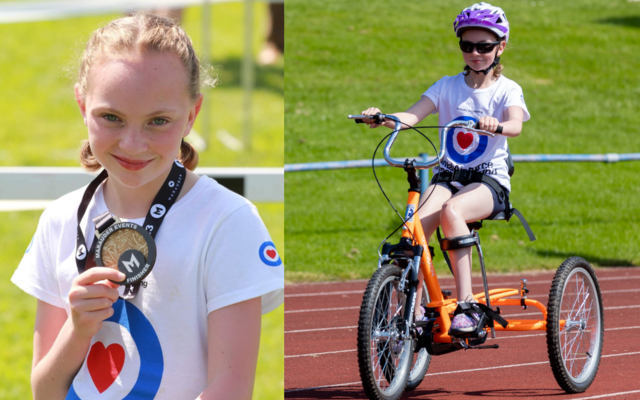 Emily holding medal and on trike in Fund tshirt