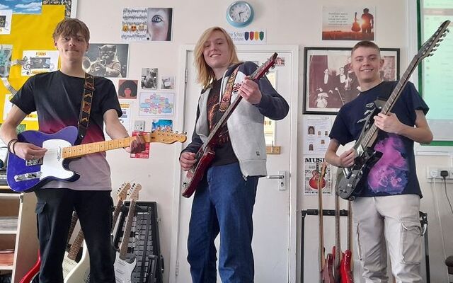 Students holding guitars