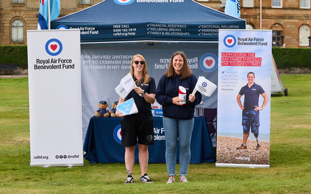 Community Engagement team at Fund welfare stand smiling holding merch