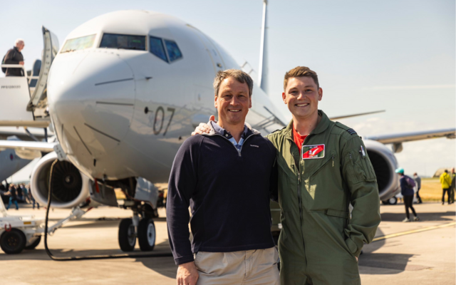Nigel and Tom standing in front of P-8 Poseidon at Lossiemouth