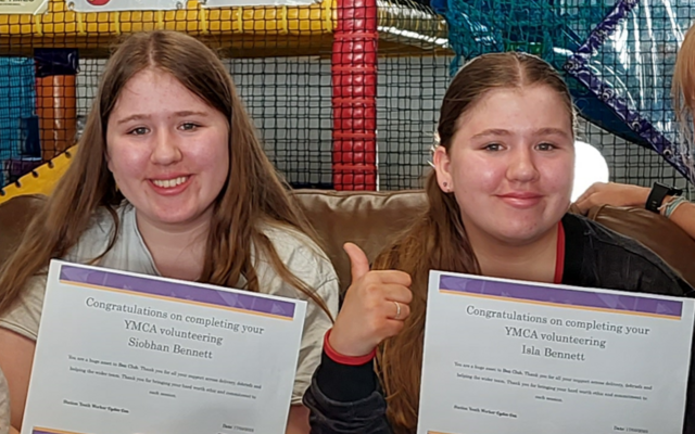 Isla and Siobhan Bennett smiling holding certificates 