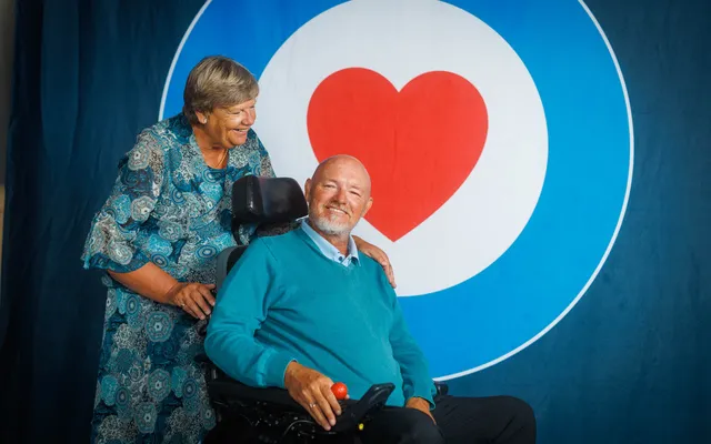 Stephen and Paula Pratley smiling in front of roundel