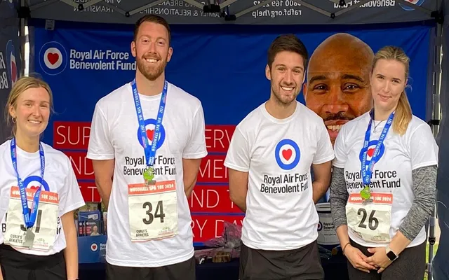 3 runners and Liam standing smiling in Fund tshirts