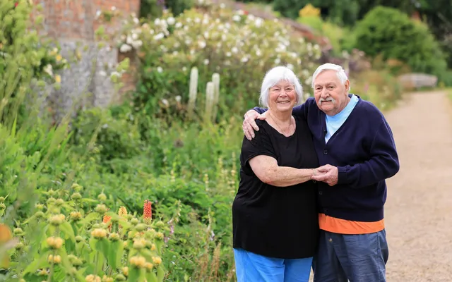 Anne and Ian Amstad arms around each other smiling