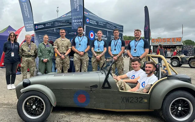 Volunteers standing with Caterham car at Grand Prix