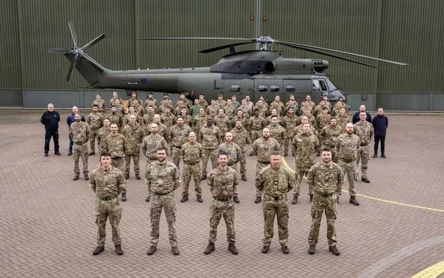 RAF Squadron in front of helicopter