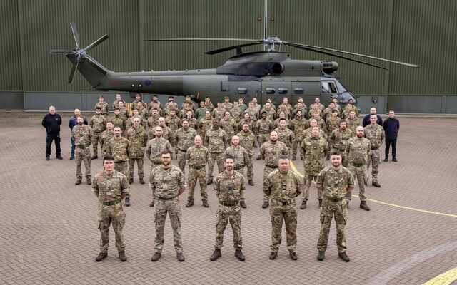 RAF Squadron in front of helicopter