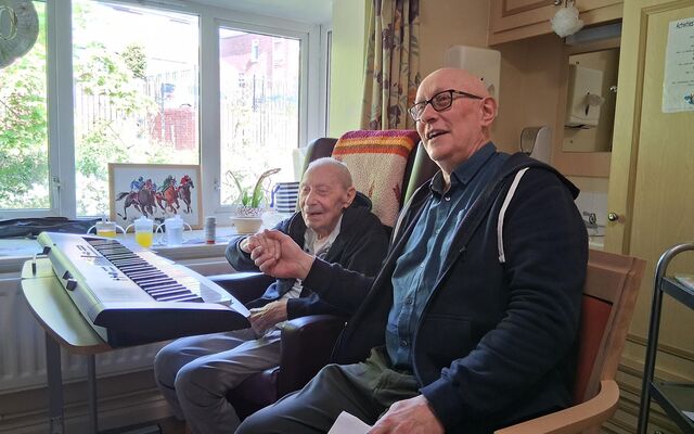 Doug Felgate with Paul learning piano