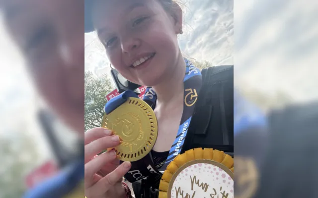 Bronwyn holding her London marathon medal
