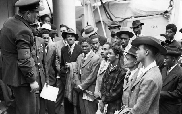 Arrivals on board the ex-troopship, HMT Empire Windrush at Tilbury. An RAF recruiting officer speaks to a group of men interested in joining the Royal Air Force. 22 June 1948