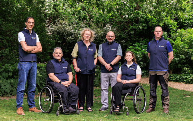6 of the ambassadors in their Fund gilets posing in the garden