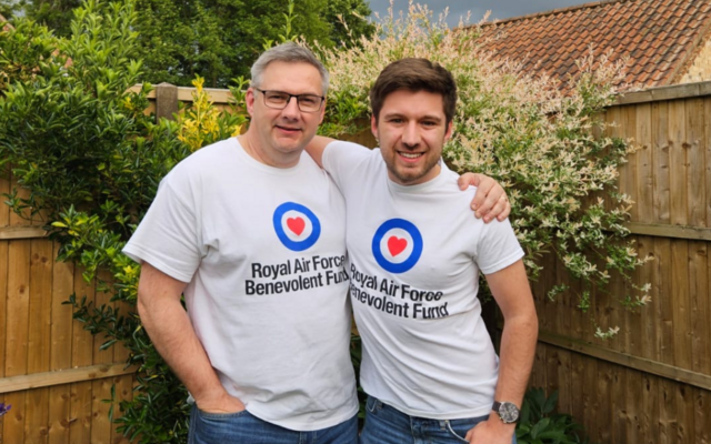Liam and dad arms around each other in garden wearing fund logo tshirts