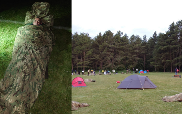Personnel in camo sleeping bag and tents across field