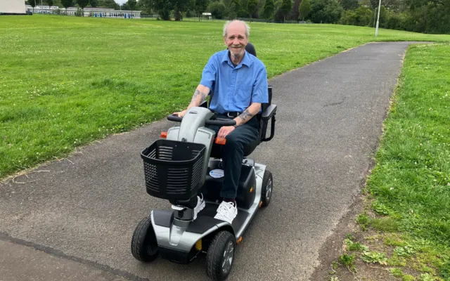 Robert on his mobility scooter in park
