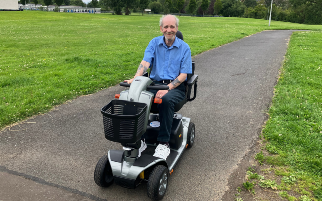 Robert on his mobility scooter in park