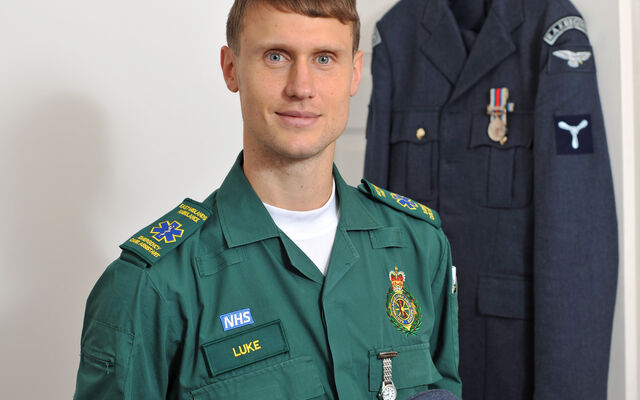 RAF personnel in uniform stood in front of his bedroom door
