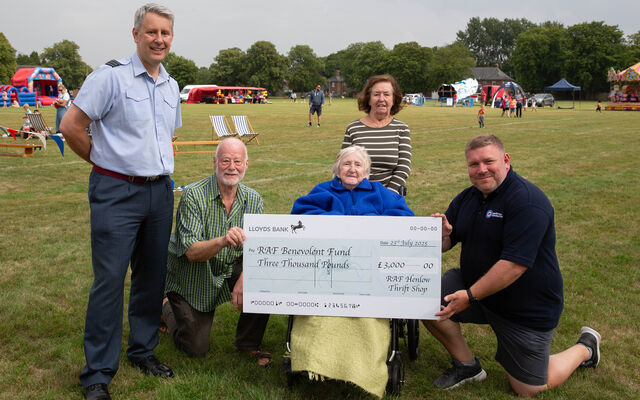 Personnel and veterans holding cheque