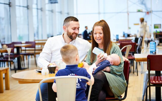 An RAF family sat at a cafe table