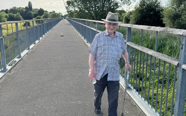 Joe walking on a bridge