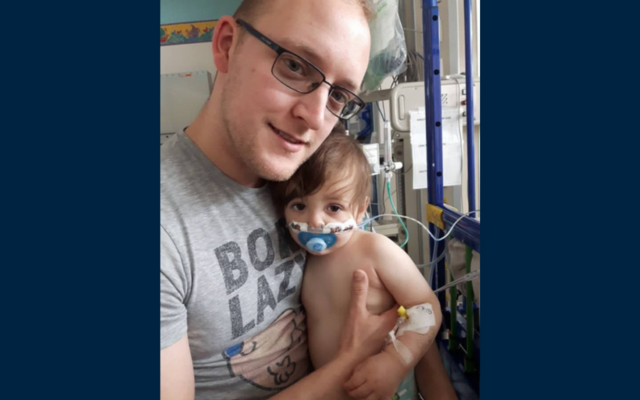 John holding Henry in hospital