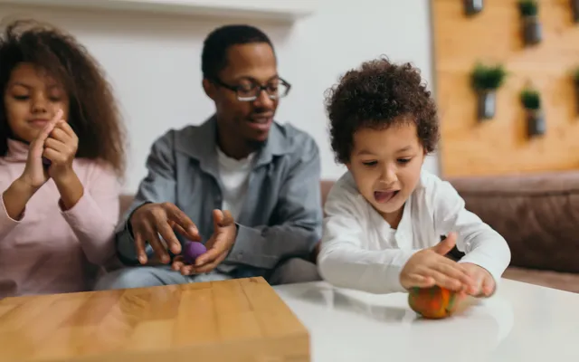 2 children and parent playing together