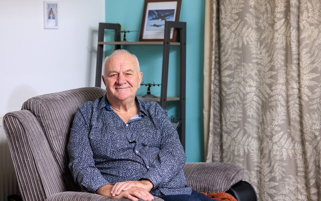 RAF veteran sitting on chair in living room