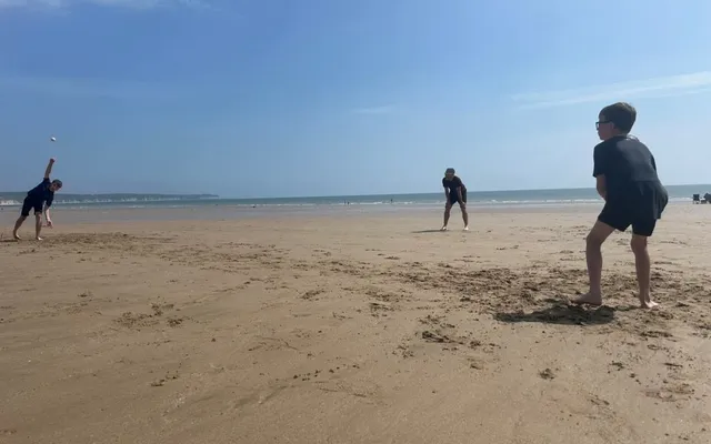 Family playing a game at the beach