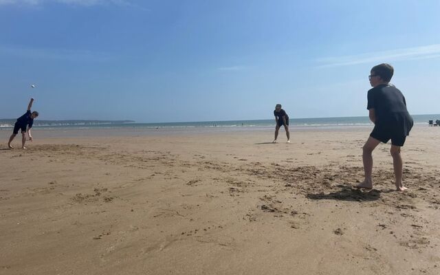Family playing a game at the beach
