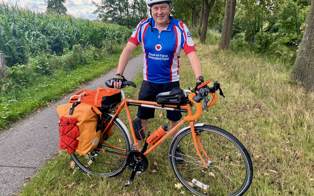 Tony standing with bike in Fund vest in Arnhem