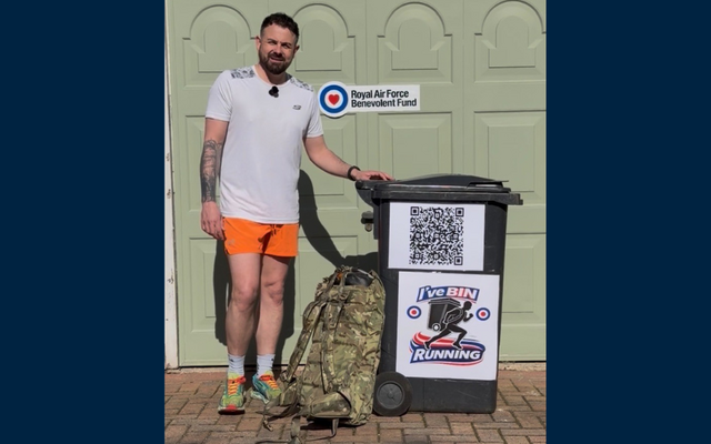 Jaime standing with camo backpack and wheelie bin