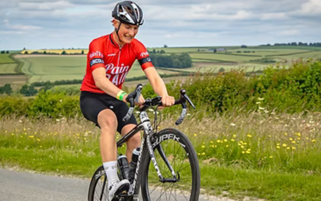 Lincoln Castle to Coast to Castle rider doing a wheelie in the countryside