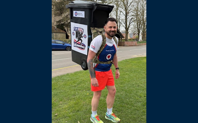 Jaime in Fund vest orange shorts and wheelie bin on back