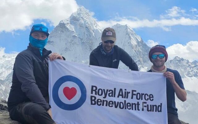 Rowan and two others on Mount Everest climb holding Fund banner