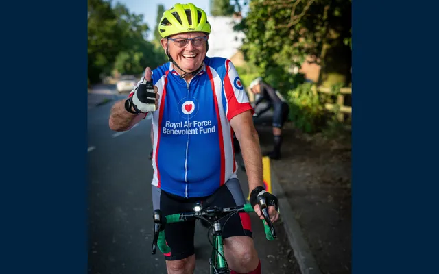 Des in Fund shirt on bike smiling