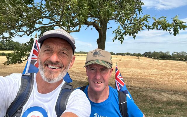 John and Simon smiling in front of field