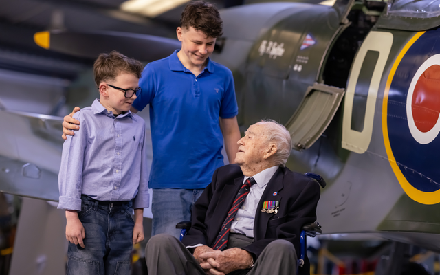 Three people infront of an aircraft