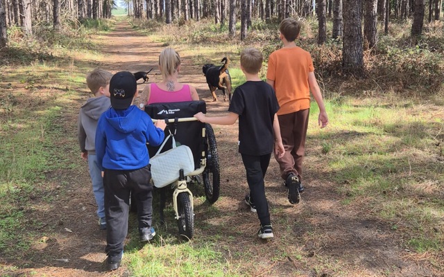 Bobbie and family in woods walking