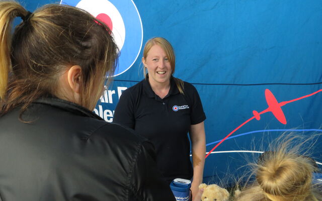 A worker from the Royal Air Force Benevolent at their Ayr Show marquee, speaking with a member of the RAF Family.