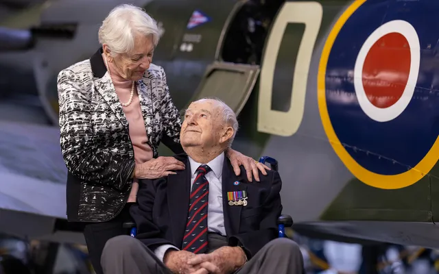 Veteran couple with aircraft in the background
