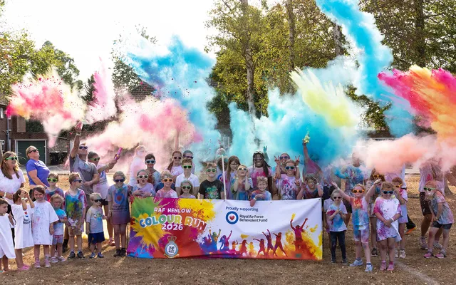 RAF Henlow children pose in streams of colour powder and Fund tshirts