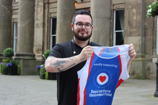 Toby holding Fund tshirt