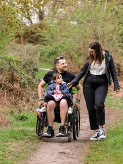 Fund beneficiary, Neil Fellingham and his family in conversation, travelling through the woods.