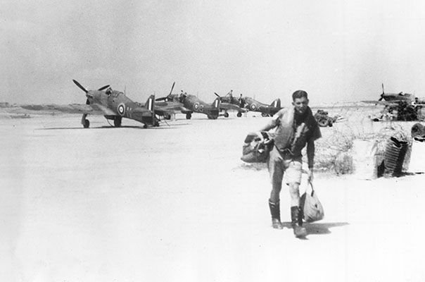 A pilot leaves the dispersal at Ta Kali, Malta, where Hawker Hurricane IIs of the Malta Night Fighter Unit are parked after a recent sortie in September 1941. (UK Crown Copyright / MOD. Courtesy of Air Historical Branch, RAF)