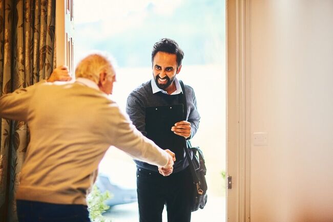 A caseworker visiting someone at home