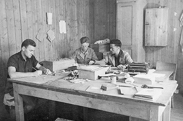 British prisoners of war produce news sheets in one of the huts at Stalag Luft III PoW camp.