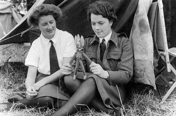 Two WAAF nursing orderlies with 50 Mobile Field Hospital in Normandy relax in between duties.