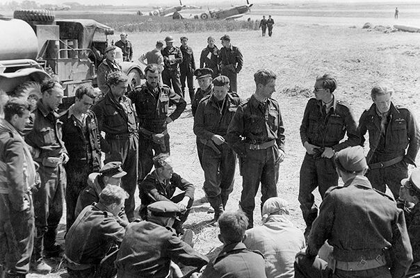 Hawker Typhoon pilots of 121 and 124 Wings discuss operations at B2/Bazenville, Normandy, on the evening of 14 June 1944.