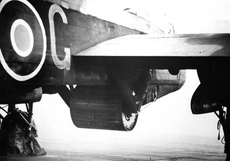 Upkeep bomb underneath a Lancaster bomber. Image: Ministry of Defence, Air Historical Branch.