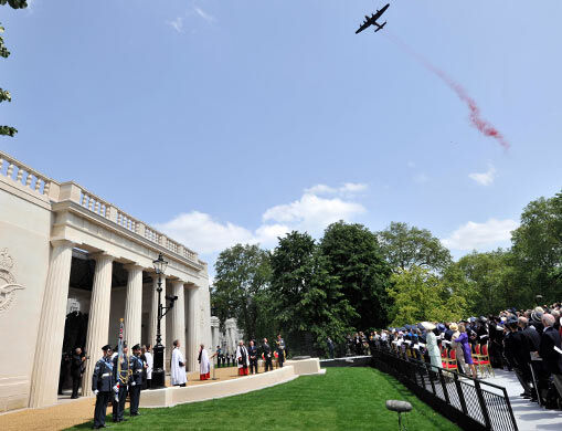 A Lancaster drops poppies over the Bomber Command Memorial.