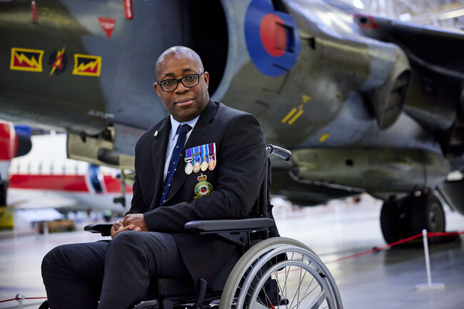 Leroy Francis in wheelchair in front of plane